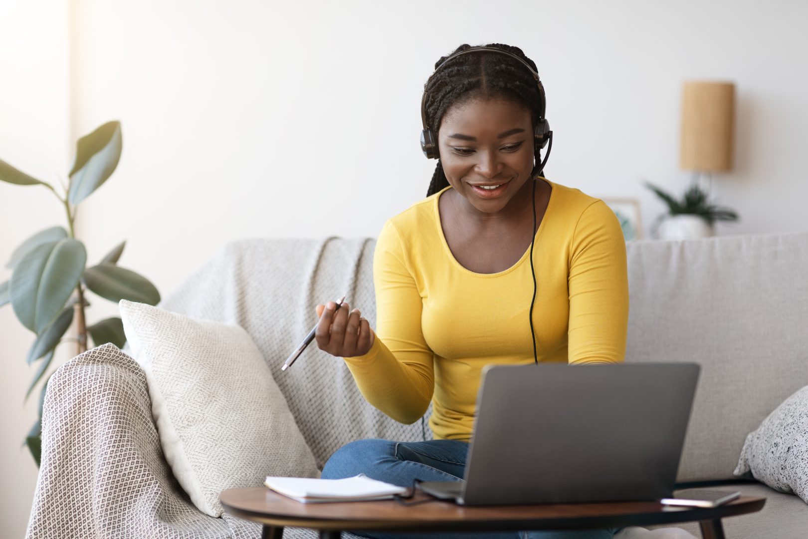 Black woman working at home with laptop.